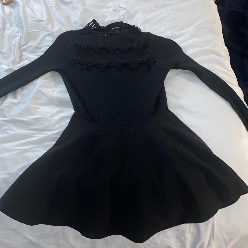 Mini black turtleneck dress with long sleeves and sheer front